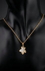 Gold necklace with a pendant on a black mannequin