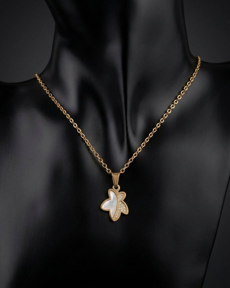 Gold necklace with a pendant on a black mannequin