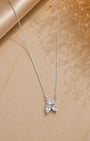 Silver 925 necklace with a leaf-shaped pendant on a beige fabric background