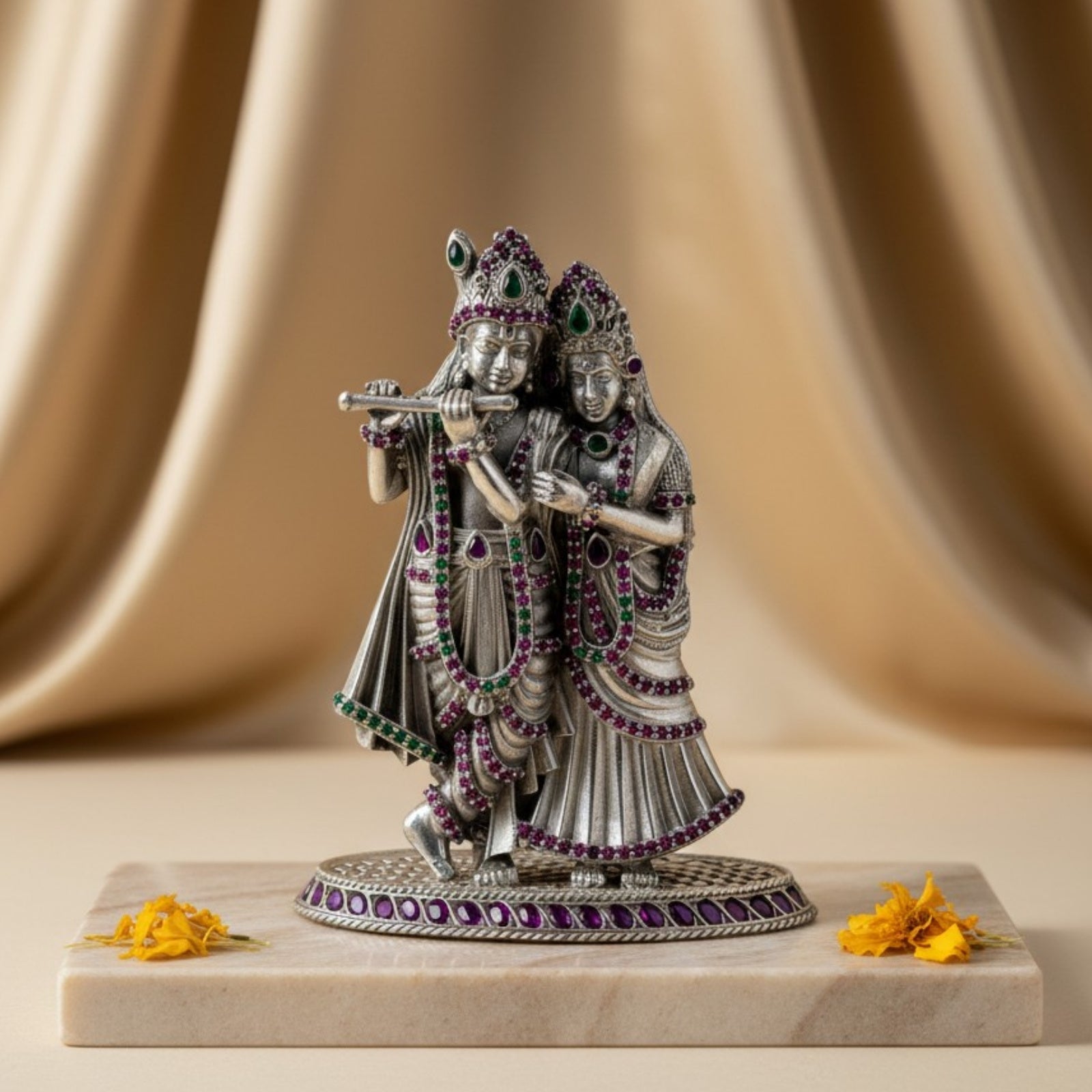 Product Image of Rajatva Radha Krishna Pure Silver Idol on a marble base with a beige curtain background.
