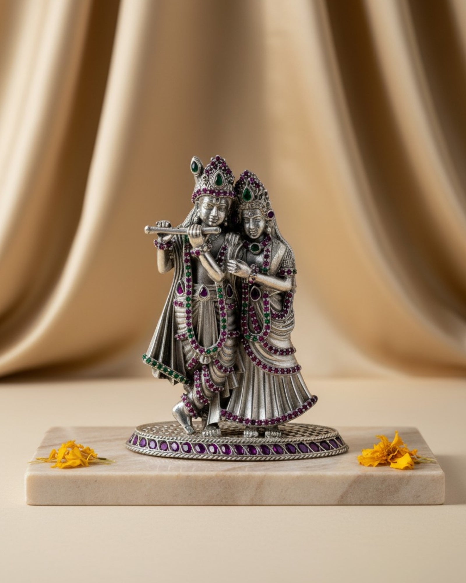 Product Image of Rajatva Radha Krishna Pure Silver Idol on a marble base with a beige curtain background.